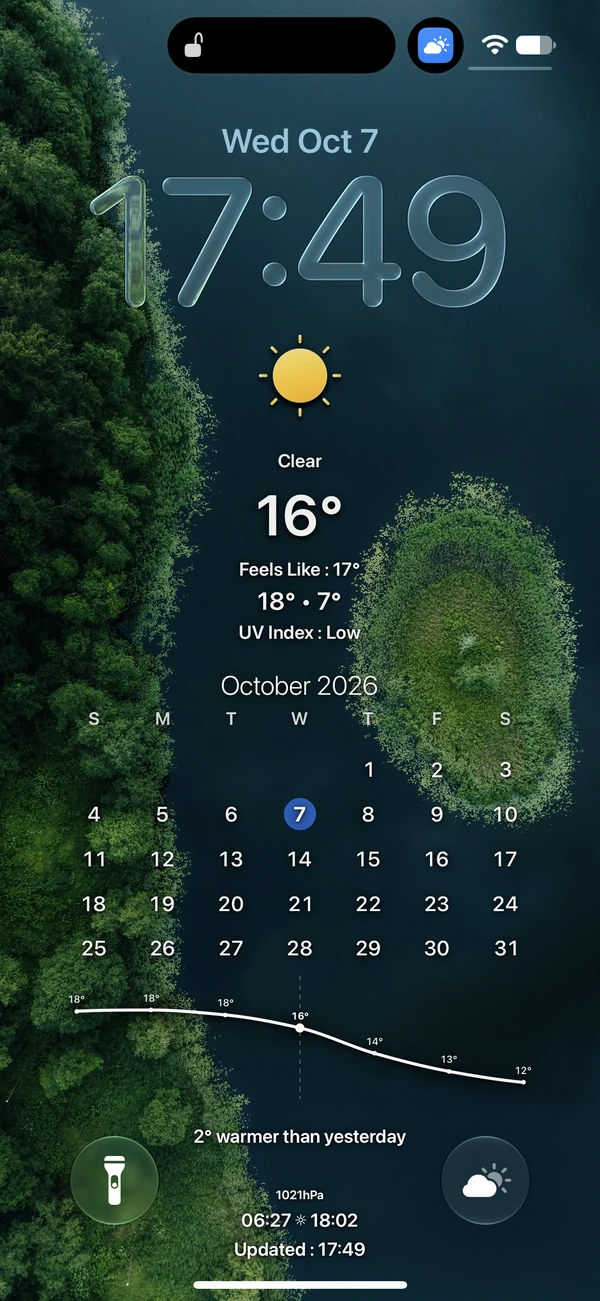 A forest and lake with weather and a calendar on an iPhone lock screen